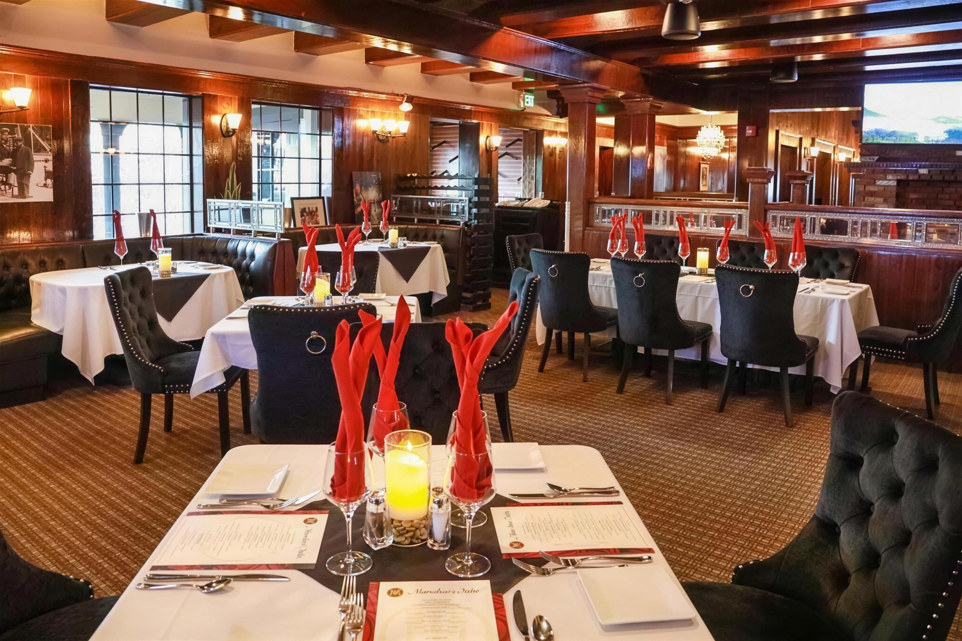 Marcolino's dining room with white tablecloths and red napkin fans, warm wood-paneled interior