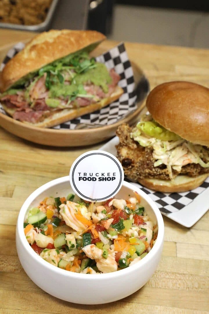 Prawn ceviche, Reuben sandwich and burger from Truckee Food Shop on a wood counter