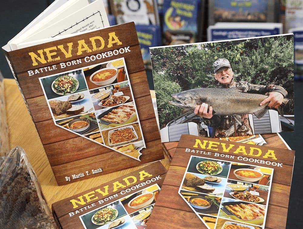 Copies of the Nevada Battle Born Cookbook fanned on a wood surface
